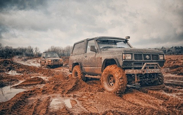 A truck driving down a dirt road