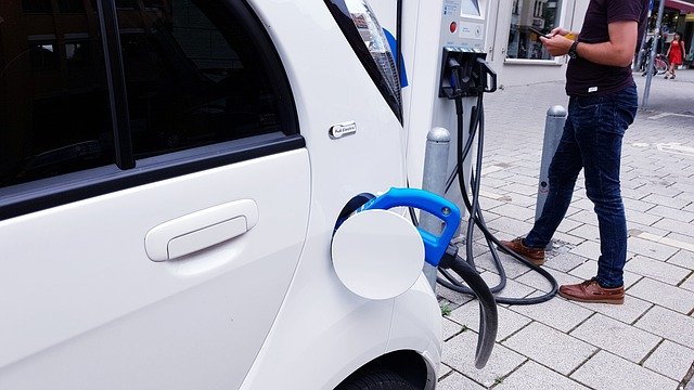 A person standing in front of a car