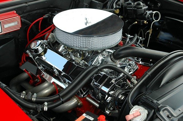 A motorcycle parked next to a car engine